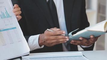 Financial analysts analyze business financial reports on a digital tablet planning investment project during a discussion at a meeting of corporate showing the results of their successful teamwork. video