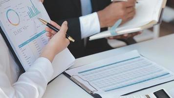 Financial analysts analyze business financial reports on a digital tablet planning investment project during a discussion at a meeting of corporate showing the results of their successful teamwork. video