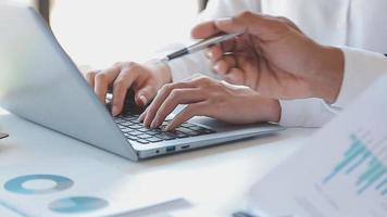 Financial analysts analyze business financial reports on a digital tablet planning investment project during a discussion at a meeting of corporate showing the results of their successful teamwork. video
