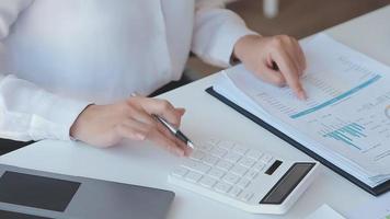 Financial analysts analyze business financial reports on a digital tablet planning investment project during a discussion at a meeting of corporate showing the results of their successful teamwork. video