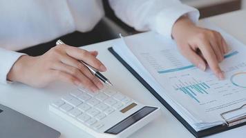 Financial analysts analyze business financial reports on a digital tablet planning investment project during a discussion at a meeting of corporate showing the results of their successful teamwork. video