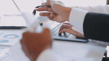 Financial analysts analyze business financial reports on a digital tablet planning investment project during a discussion at a meeting of corporate showing the results of their successful teamwork. video