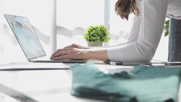 Diverse female fashion designers at work with tailor centimeters on necks and holds tablet and notepad. independent creative design business. video