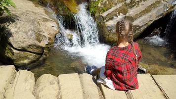 Little girl enjoying view of waterfall in Krasnay Poliana video