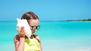 Portrait of little cute girl with a big seashell video