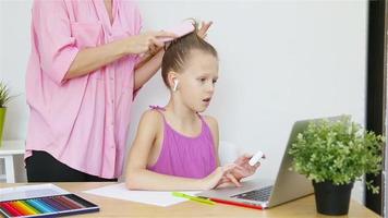 Mother is combing her daughter's hair video