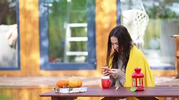 Woman enjoying in autumn day while drinking coffee video