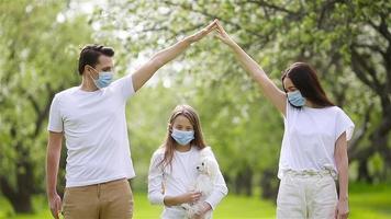 Adorable family in blooming cherry garden in masks video