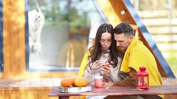 Young couple sitting on the wooden old table in the autumn forest video