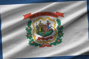 West Virginia US state flag with big folds waving close up under the studio light indoors. The official symbols and colors in banner photo