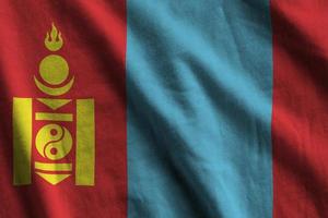 Mongolia flag with big folds waving close up under the studio light indoors. The official symbols and colors in banner photo