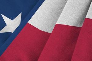 Texas US state flag with big folds waving close up under the studio light indoors. The official symbols and colors in banner photo