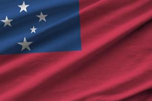 Samoa flag with big folds waving close up under the studio light indoors. The official symbols and colors in banner photo