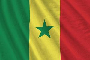 Senegal flag with big folds waving close up under the studio light indoors. The official symbols and colors in banner photo