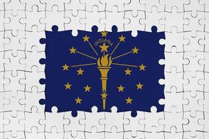 Indiana US state flag in frame of white puzzle pieces with missing central part photo