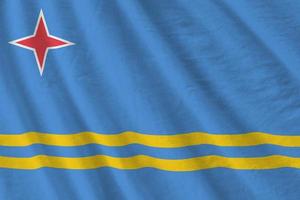 Aruba flag with big folds waving close up under the studio light indoors. The official symbols and colors in banner photo