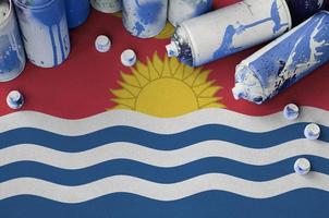 Kiribati flag and few used aerosol spray cans for graffiti painting. Street art culture concept photo