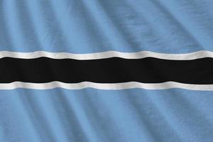 Botswana flag with big folds waving close up under the studio light indoors. The official symbols and colors in banner photo