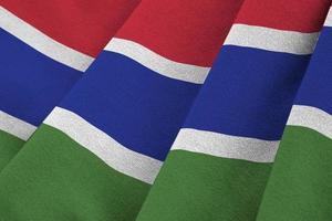 Gambia flag with big folds waving close up under the studio light indoors. The official symbols and colors in banner photo