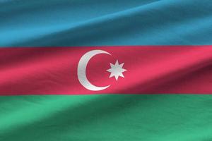 Azerbaijan flag with big folds waving close up under the studio light indoors. The official symbols and colors in banner photo