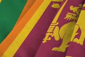 Sri Lanka flag with big folds waving close up under the studio light indoors. The official symbols and colors in banner photo
