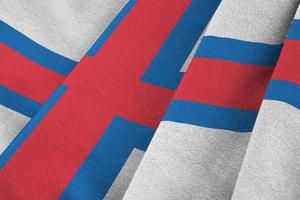 Faroe islands flag with big folds waving close up under the studio light indoors. The official symbols and colors in banner photo