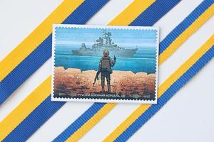 KYIV, UKRAINE - MAY 4, 2022 Famous ukrainian souvenir with russian warship and ukrainian soldier photo