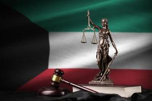 Kuwait flag with statue of lady justice, constitution and judge hammer on black drapery. Concept of judgement and guilt photo