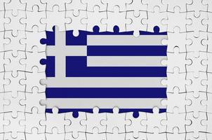 Greece flag in frame of white puzzle pieces with missing central part photo