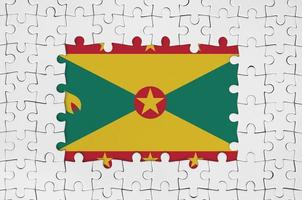 Grenada flag in frame of white puzzle pieces with missing central part photo