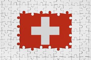 Switzerland flag in frame of white puzzle pieces with missing central part photo