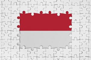 Indonesia flag in frame of white puzzle pieces with missing central part photo