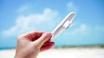 Small white miniature of an airplane toy on background of turquoise sea video