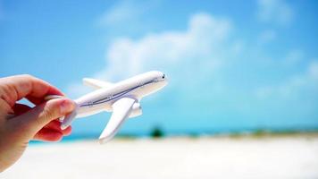 Small white miniature of an airplane on background of turquoise sea video
