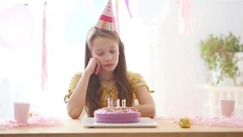 Kaukasisch meisje teleurstellend Aan haar verjaardag. feestelijk kleurrijk achtergrond met ballonnen. verjaardag partij en wensen concept. video