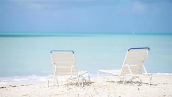 Two lounge chairs on beautiful tropical beach at Maldives video