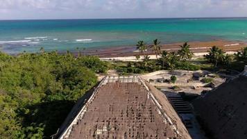 Drone video of a ruin of a luxury hotel on a tropical beach after destruction by a hurricane