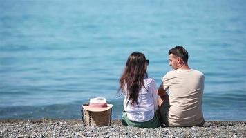 Young couple on white beach during summer vacation. video