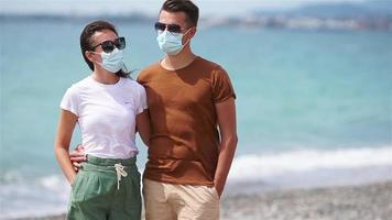 Young couple on white beach during summer vacation. video