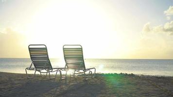 Chaise-longues on white tropical caribbean beach video