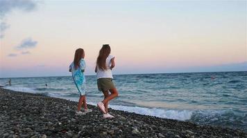 Little girls have fun at tropical beach during summer vacation video