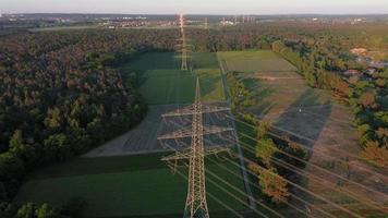 Drone video of a flight along a high voltage power line in the setting sun