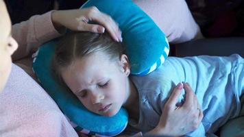 Little girl sleeping in a plane during air travel flight. Mother with daughter travel by plane video