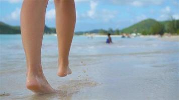 Close up female feet walking barefoot on the beach. Slow Motion. video