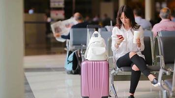 passageiro da companhia aérea em um saguão do aeroporto à espera de aeronaves de voo. mulher caucasiana procurando tempo na sala de espera video