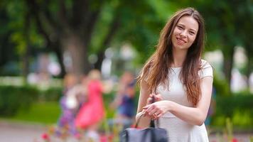 Beautiful young woman portrait outdoor. Portrait of happy beautiful woman smiling in the park video