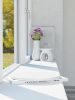 3d ceramic display podium with books and plant jar on the window apron. 3d rendering of realistic presentation for product advertising. 3d illustration with blurred background. photo