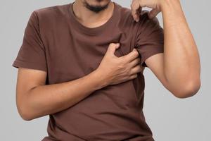 A man Uses his hand to scratch the armpit. photo