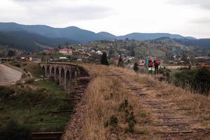 Close view of old railroad tracks with worn ties. Railway viaduct Ukraine, Verkhovyna photo