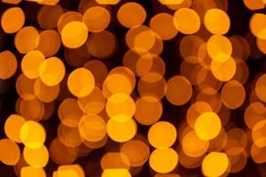 Abstract circular bokeh background of Christmaslight. bokeh from garlands. background for screensaver. Defocused lights. Blurred bokeh with yellow color lights. photo